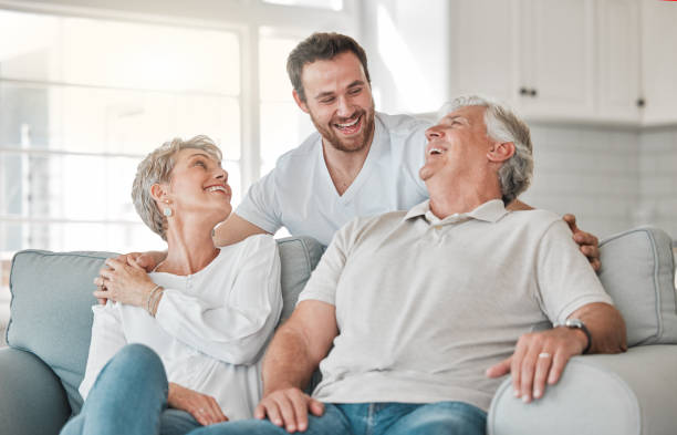 Licensed agent helping a senior couple review plans