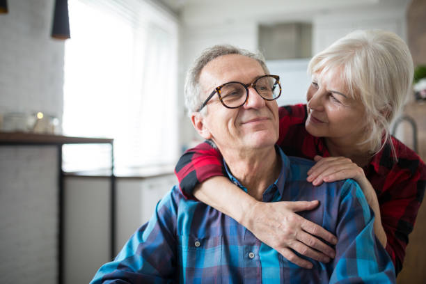 Senior couple embracing at home