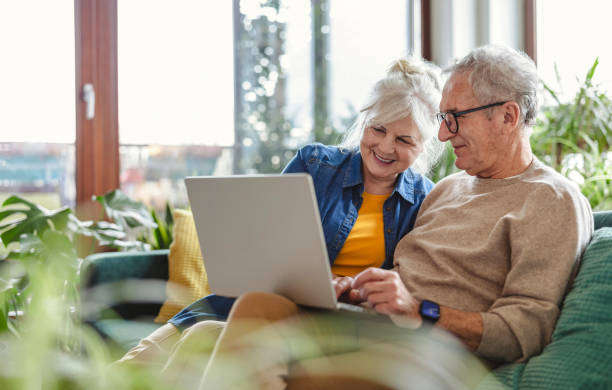 Senior couple comparing coverage options on a laptop